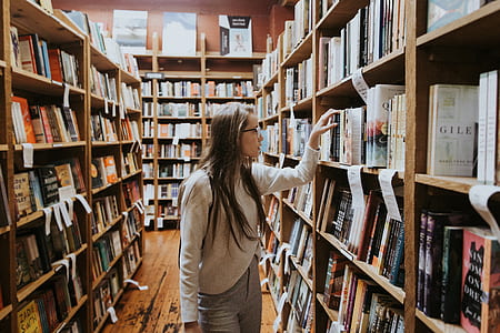 woman looking for a book in a libary thumbnail