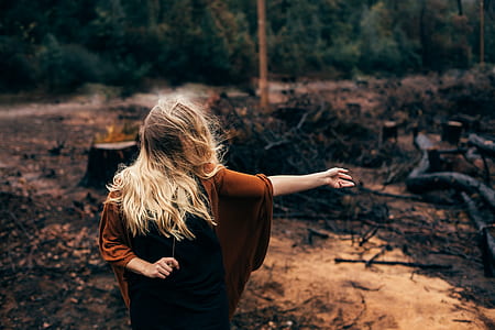 woman standing near tree stumps thumbnail