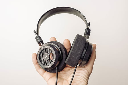 person holding black headphones thumbnail