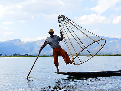 person standing on boat during daytime thumbnail