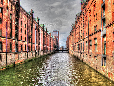 brown concrete building near body of water thumbnail