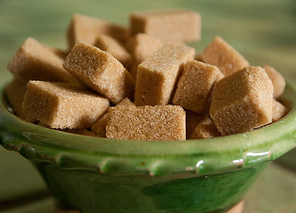 brown sugar cubes in green ceramic bowl thumbnail