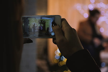 Shallow Focus Photography of Person Holding Silver Iphone 6s thumbnail