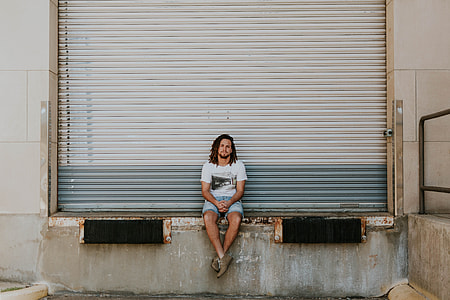 man sitting near door shutte thumbnail