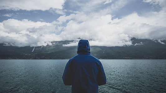 man standing near the body of water at daytime thumbnail