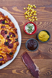 baked pizza on brown wooden surface thumbnail