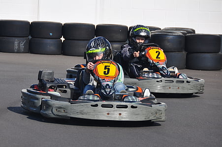 children riding black-and-gray go-karts thumbnail
