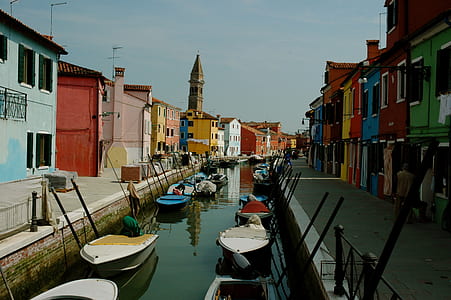 boats parked on dock in middle of body of water thumbnail