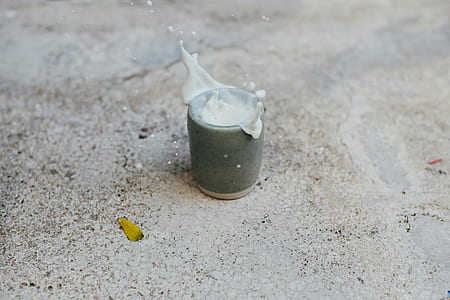 timelapse photography of spilled white substance on ceramic cup thumbnail