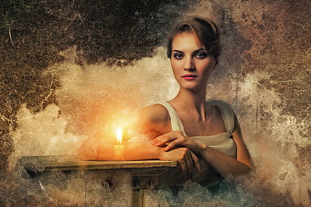 woman in white sitting on chair with white candle thumbnail