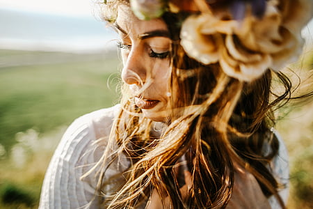 close-up photo of woman wearing white top thumbnail