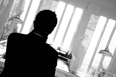 man standing inside white painted room thumbnail