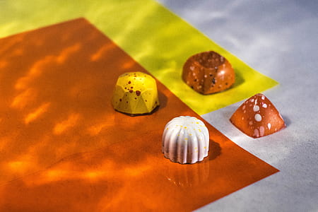 four chocolate candies on surface thumbnail