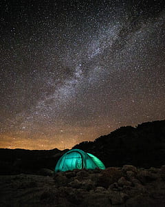 green tent during nighttime thumbnail