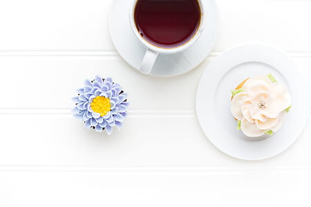 brown liquid-filled white ceramic cup on saucer thumbnail