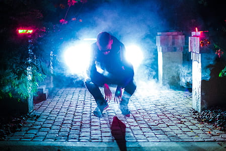 man sitting on floor near posts thumbnail