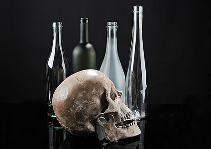 skull beside glass bottles thumbnail