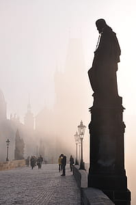 people walking on bridge with statue thumbnail