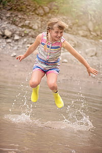 jumping brown haired girl on body of water thumbnail
