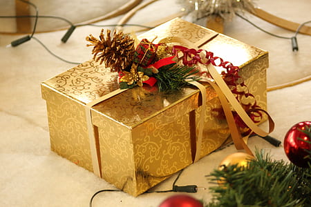 gold-colored floral gift box on beige surface thumbnail