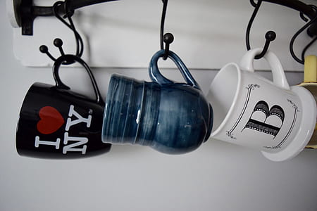 three blue, black, and white ceramic mugs thumbnail