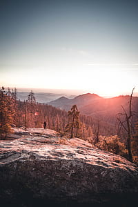 person on top of mountain during sunset thumbnail