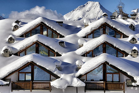 brown and white wooden house covered with snow thumbnail