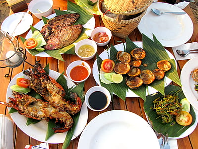 seafood dish placed on banana leaves thumbnail