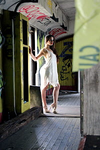 woman wearing white tank dress and brown stilettos near door thumbnail