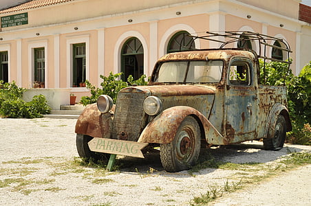 rustic single-cab pickup truck near beige and white painted house taken during daytime thumbnail