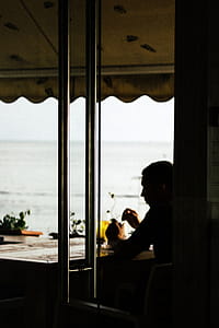 Silhouette of Man Sitting at Table thumbnail