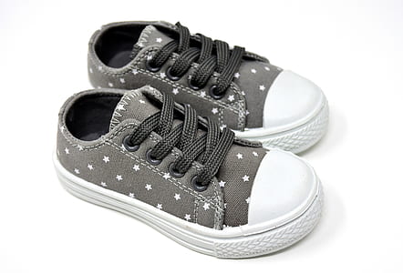 pair of girl's gray-and-white low-top sneakers on white surface thumbnail