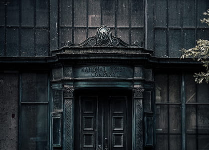 wooden door with National Trust Company signage on top thumbnail