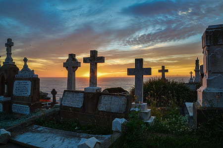 cemetery by the sea under blue and orange sky during sunset thumbnail
