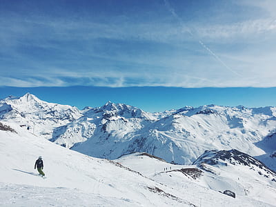 person snowboarding on top of snow covered mountain thumbnail
