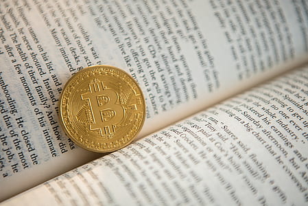gold-colored coin on book thumbnail