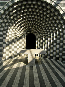 grey and white striped optical illusion concrete tunnel hallway with table thumbnail
