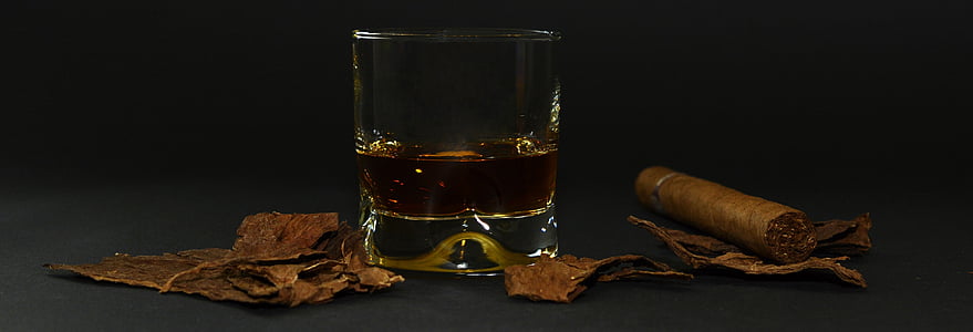 rocks glass with brown liquid on brown surface thumbnail