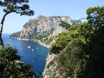 island with green leaf trees under blue sky thumbnail