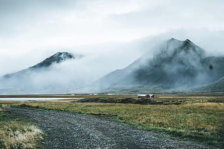green grassland in front of two mountains thumbnail