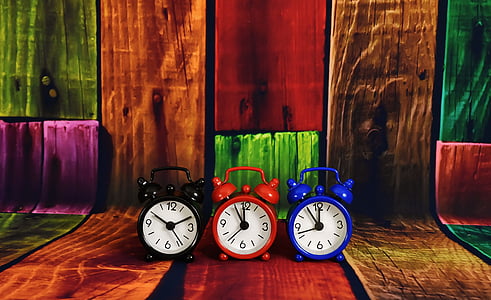 three black, red, and blue dual-bell alarm clocks thumbnail