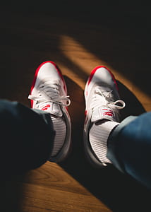 pair of white-and-red Nike low-top sneakers thumbnail
