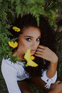 woman sitting under yellow petaled flower thumbnail