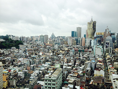 high-angle photography of city under nimbus clouds thumbnail