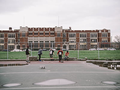 five men skating on gray concrete pavement at daytime thumbnail