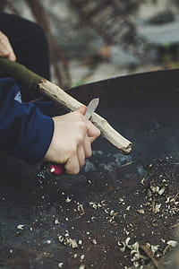 person carving wood branch thumbnail