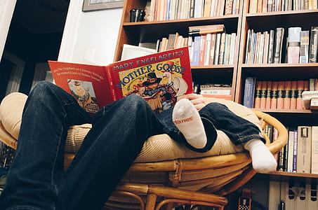 person sitting on papasan chair with child inside room thumbnail