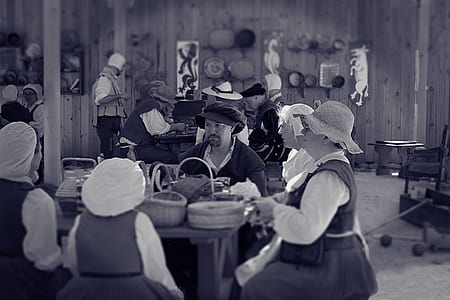 Man Sitting Between Female Near Table thumbnail