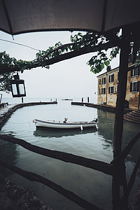 mirror photography of white and black motor boat thumbnail