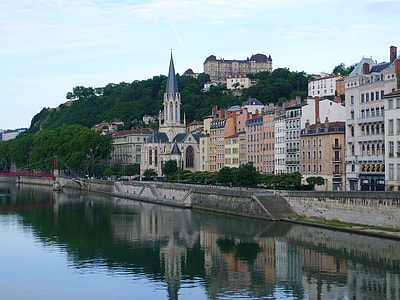 calm body of water beside concrete buildings at daytime thumbnail